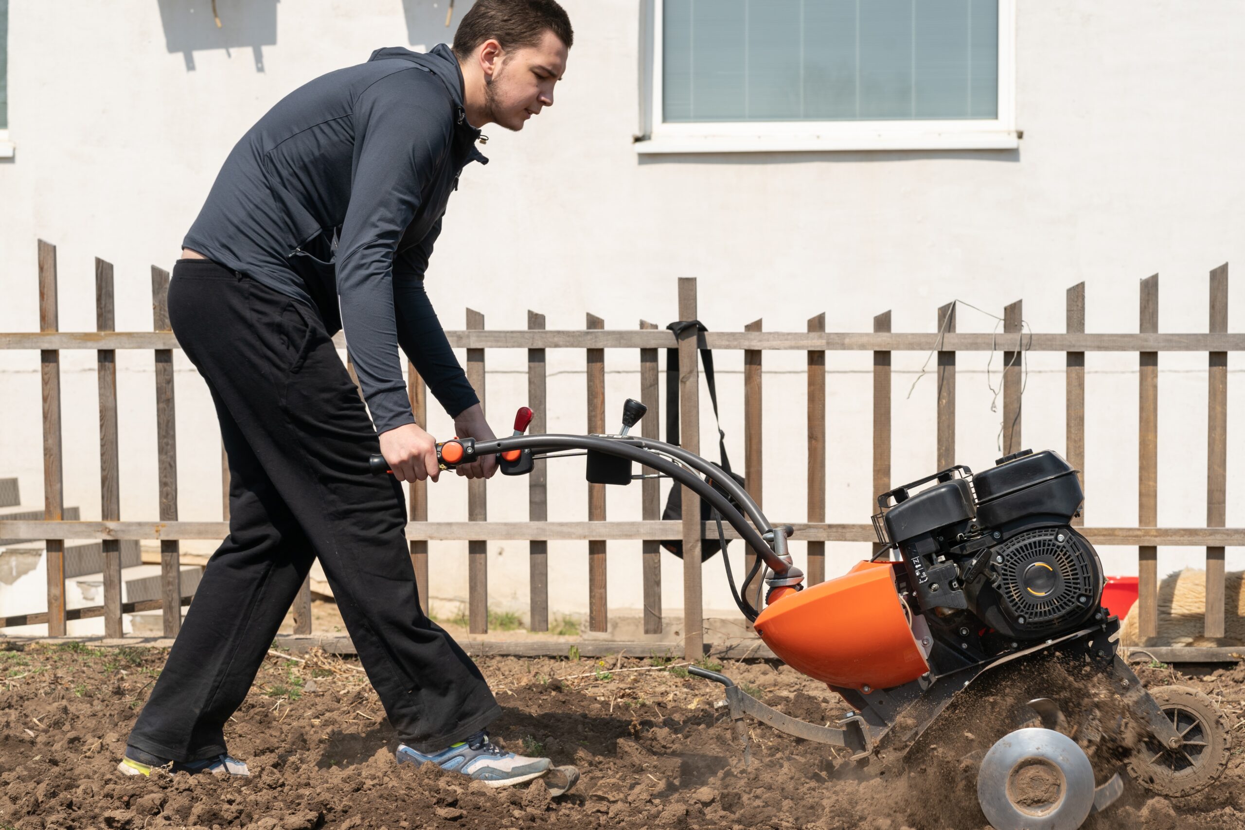 a-young-man-digs-the-ground-in-the-garden-with-a-m-2025-02-10-10-14-29-utc