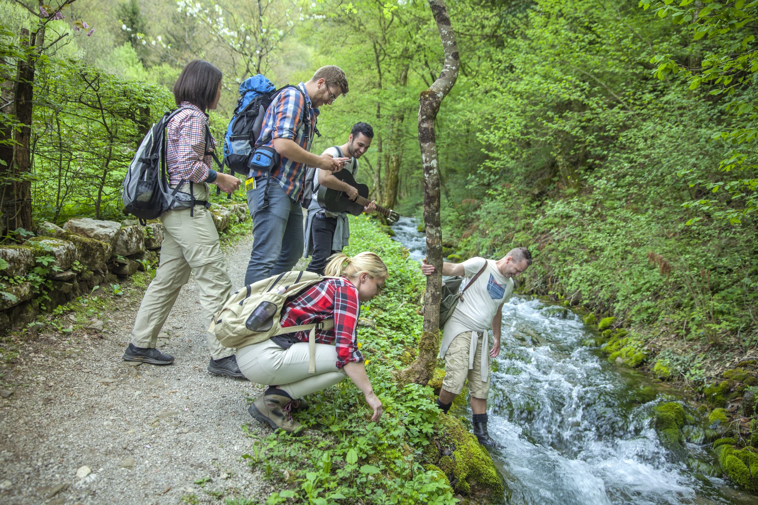 A group of friends in a forest by the river